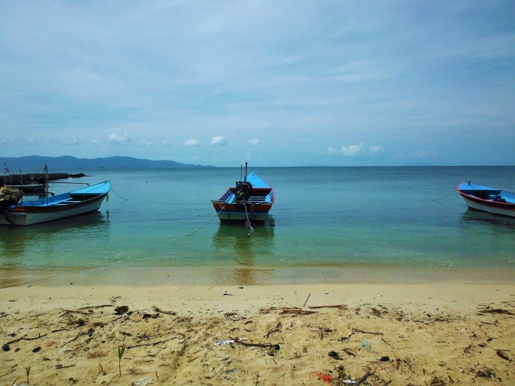 boats in shallow water on beach, thailand
