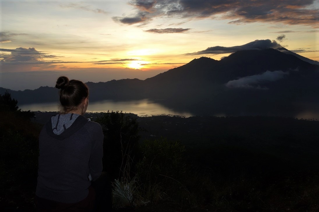 sitting and watching sunrise from top of mt batur