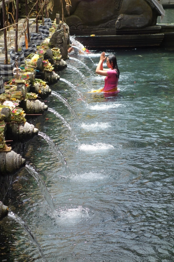 woman bathing in holy water temple, bali