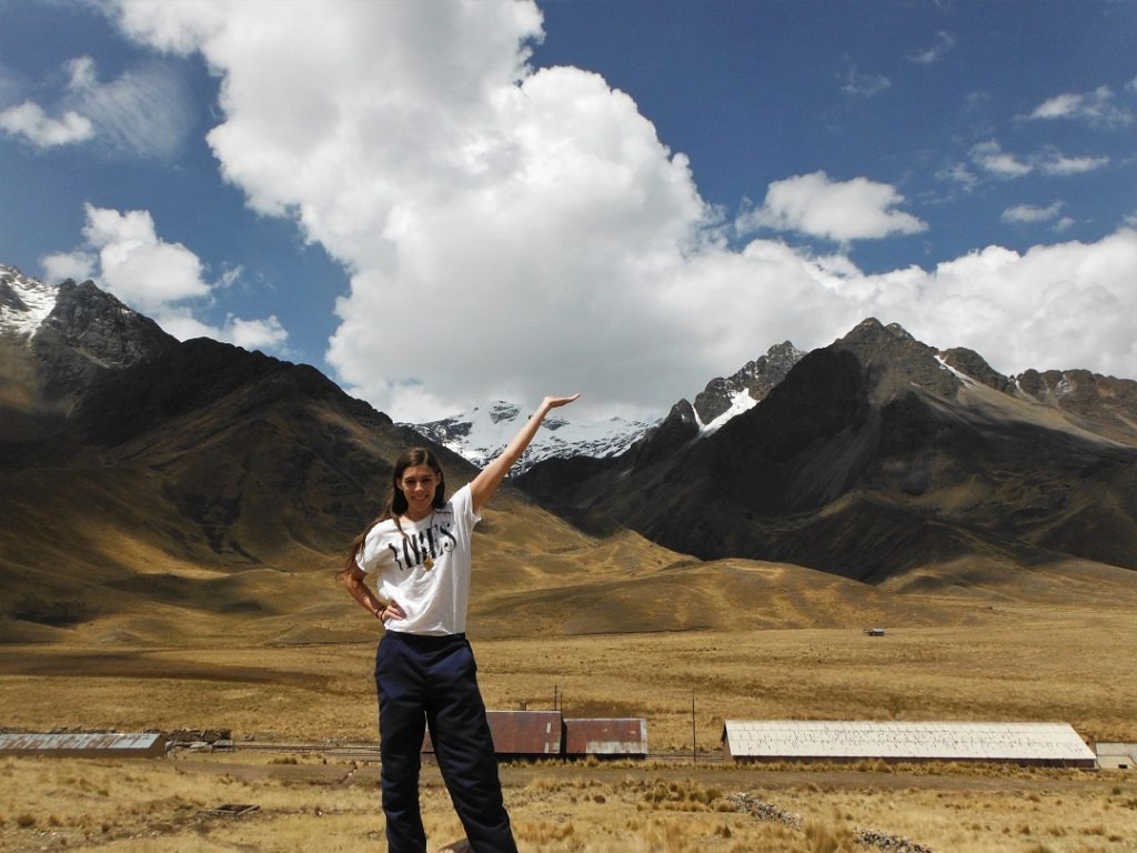 posing with snowcapped mountains in background, peru