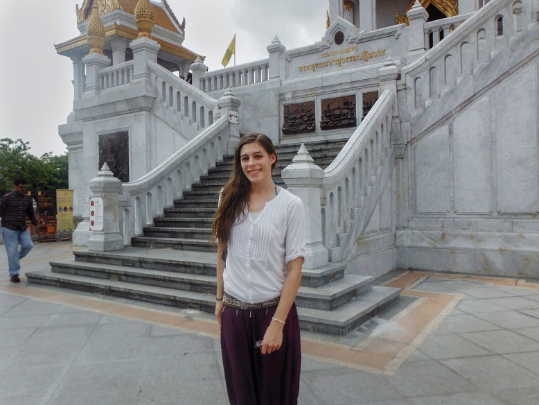 posing in front of a temple in thailand