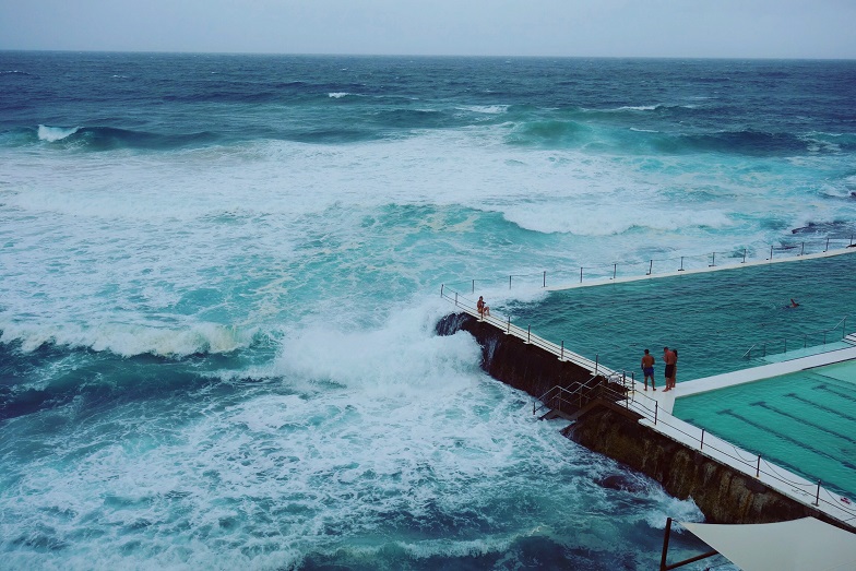 waves breaking over open pool, Australia