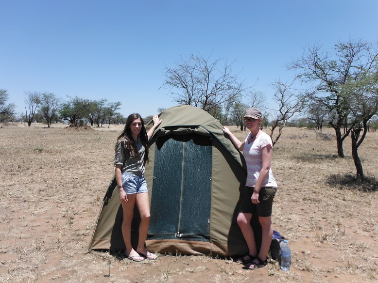 posing by tent, serengeti, tanzania