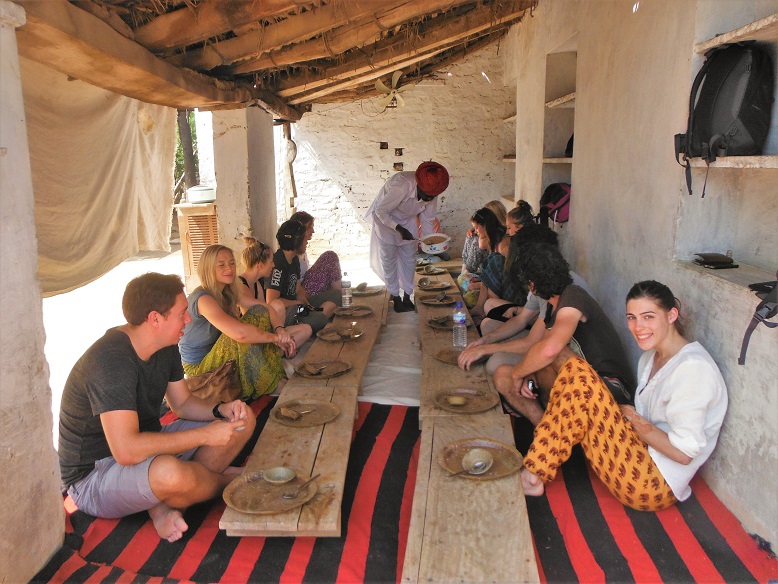 tour group eating on floor in india