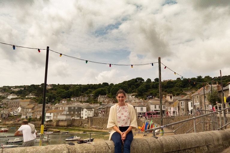 sitting on the harbour wall, Mousehole, Cornwall.