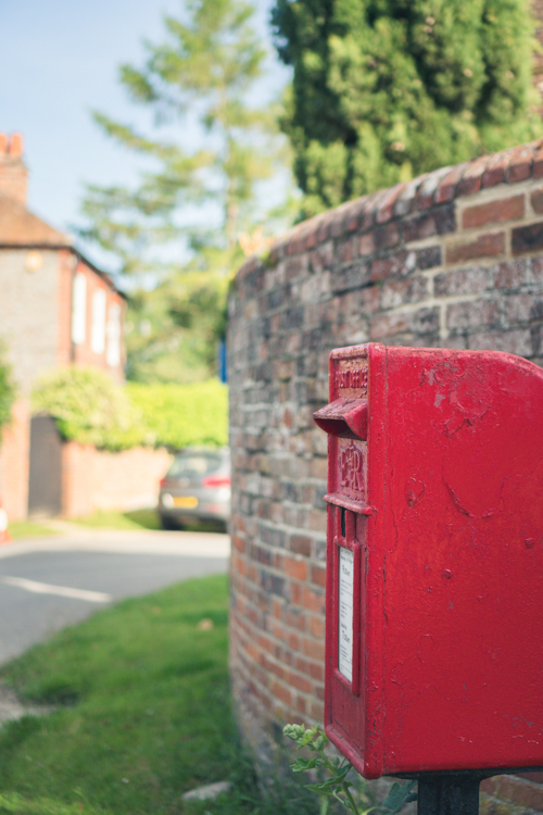 red post box in small village lane, walks in England