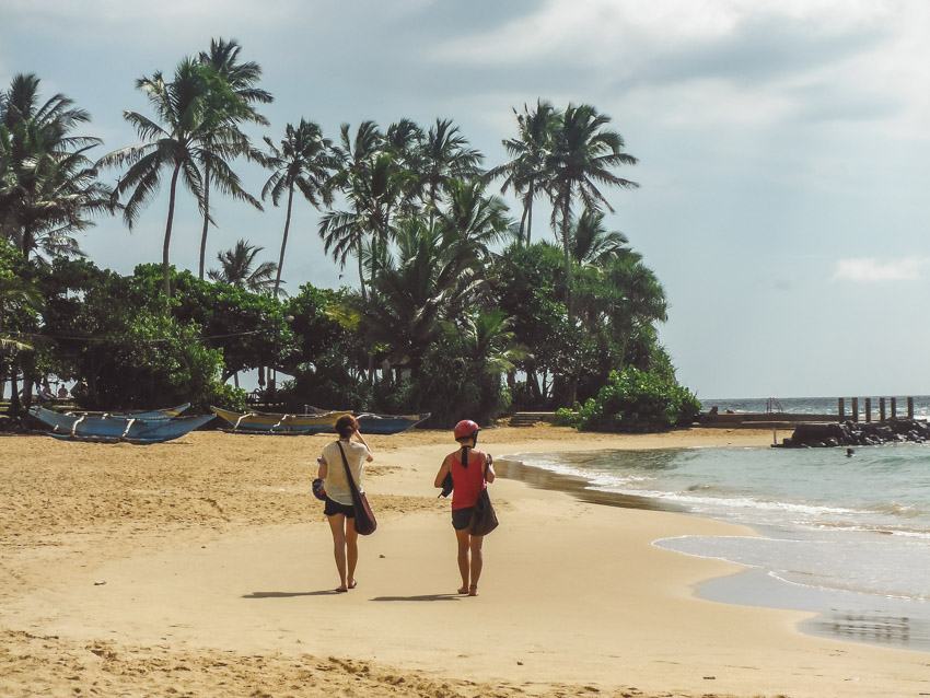 tourists walking Hikkaduwa beach Sri Lanka