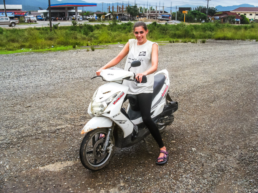 sitting on a rented moto in Laos