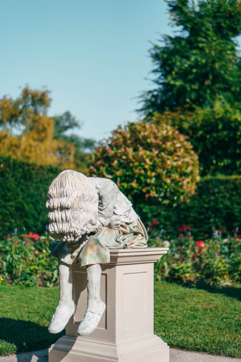 statue of young girl in formal gardens