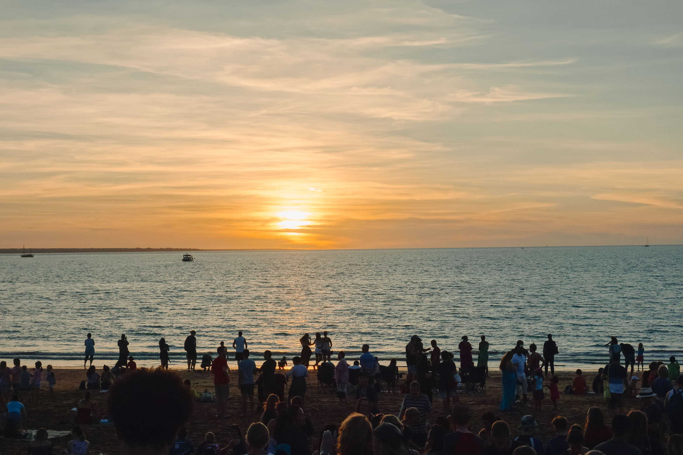 people watching sunset over ocean