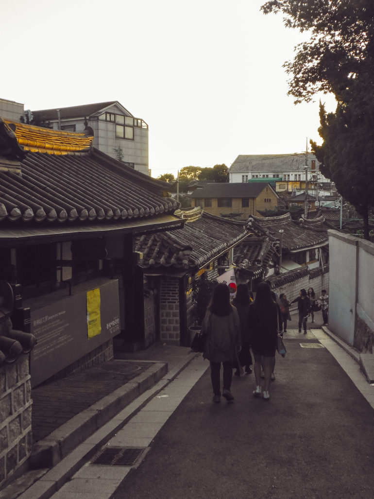 people walking down hanok village Seoul