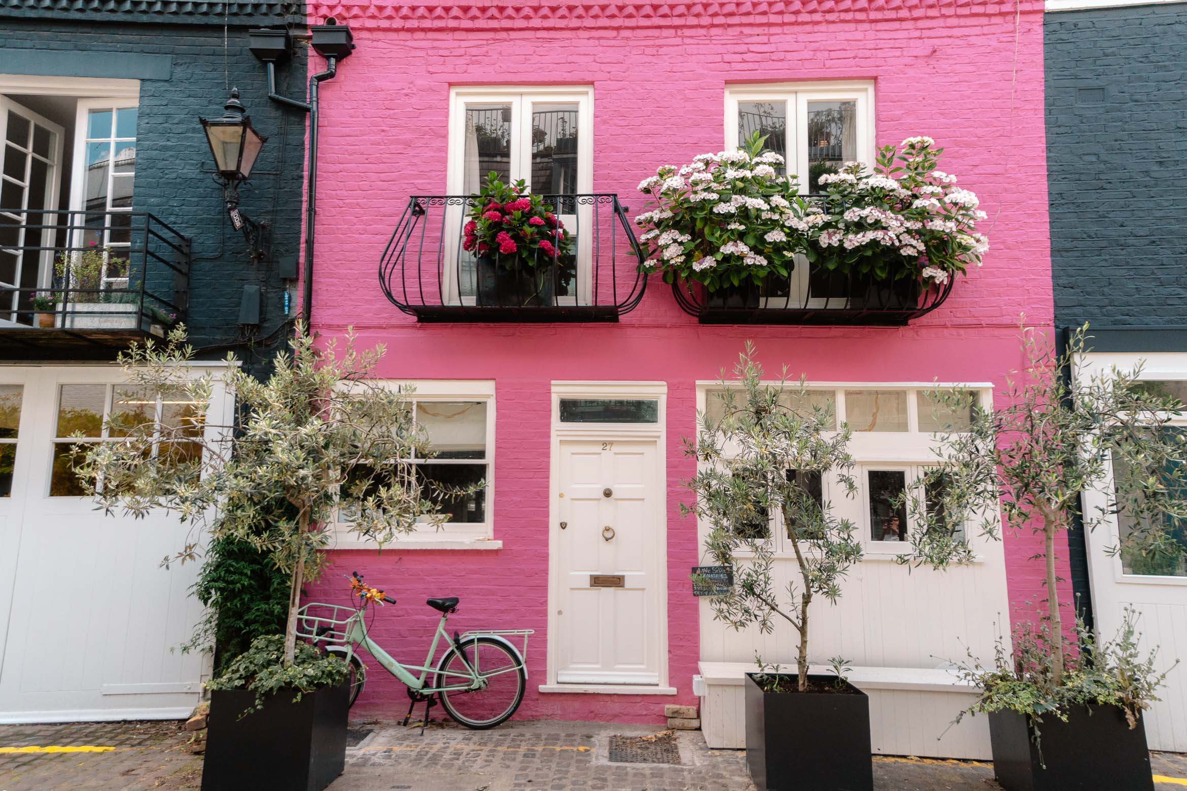 pink painted house with flowers outside in notting hill