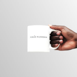 hand holding out white female wanderess mug