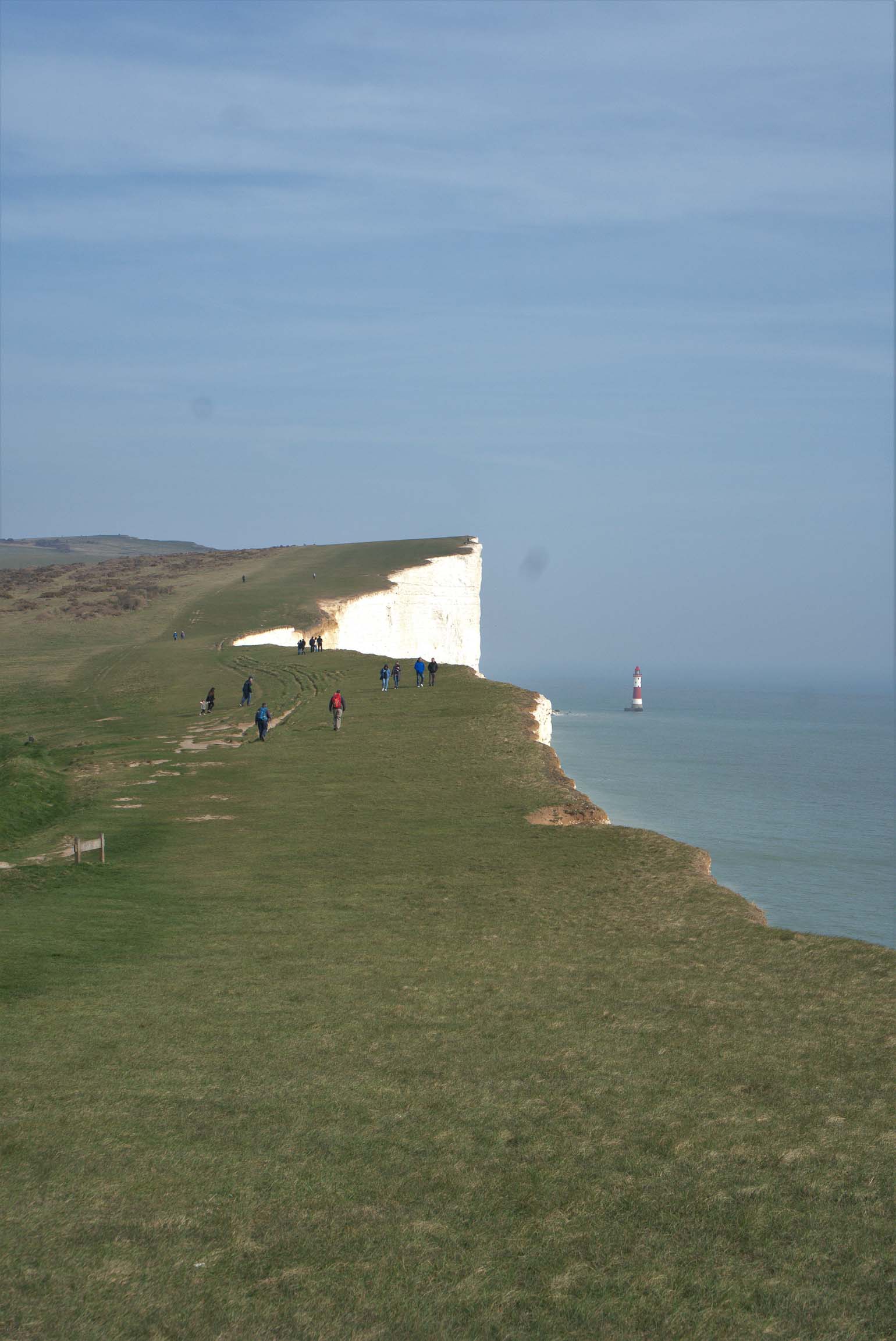 people walking cose to eastbourne cliff edge